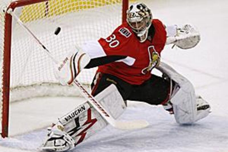 Ottawa Senators goaltender Brian Elliott makes a stick-save against the Buffalo Sabres.