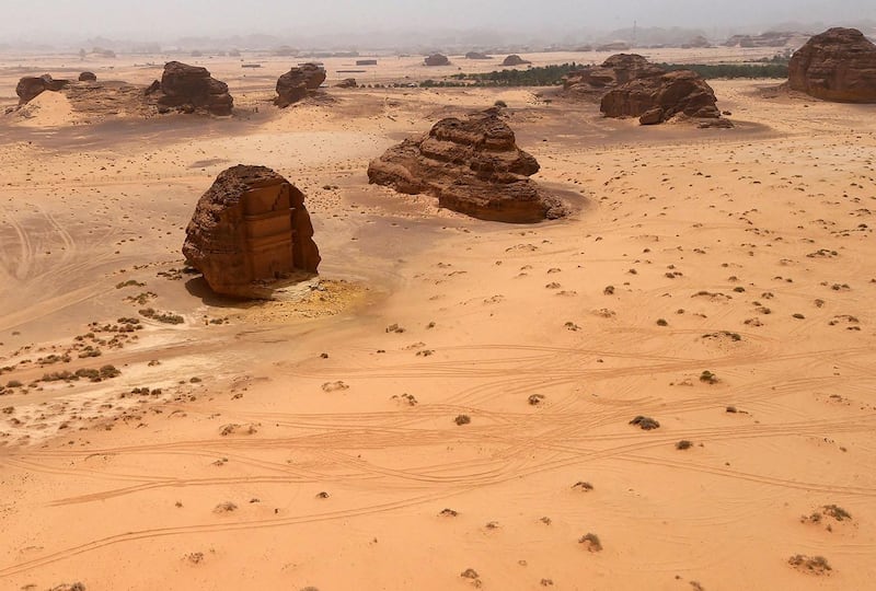 A picture taken on April 1, 2018 shows an aerial view of the Qasr al-Farid tomb (The Lonely Castle) carved into rose-coloured sandstone in Madain Saleh, a UNESCO World Heritage site, near Saudi Arabia's northwestern town of al-Ula. - Al-Ula, an area rich in archaeological remnants, is seen as a jewel in the crown of future Saudi attractions as the austere kingdom prepares to issue tourist visas for the first time -- opening up one of the last frontiers of global tourism. Saudi Crown Prince Mohammed bin Salman is set to sign a landmark agreement with Paris on April 10, 2018 for the touristic and cultural development of the northwestern site, once a crossroads of ancient civilisations. (Photo by FAYEZ NURELDINE / AFP)