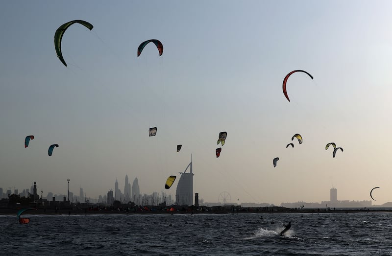 Dozens of kite surfers make the most of favourable conditions at Jumeirah Beach, Dubai. Chris Whiteoak / The National