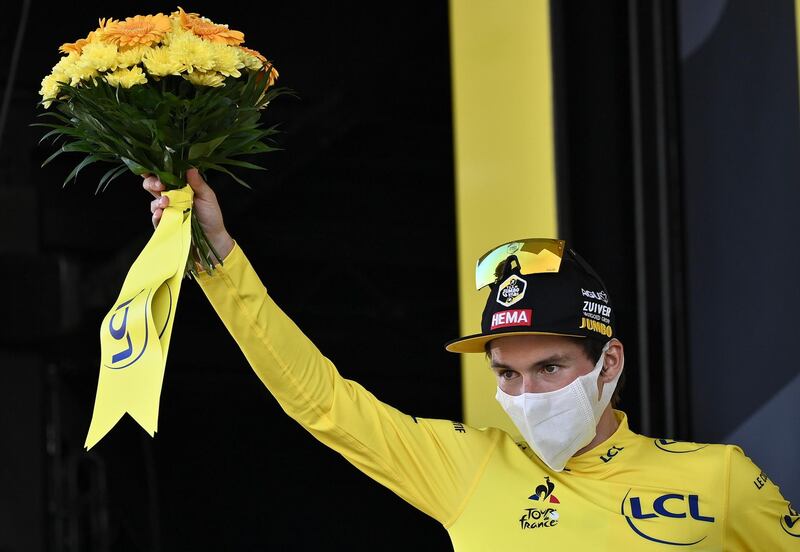 Slovenia's Primoz Roglic, wearing the leaders yellow jersey stands on the podium after the 19th stage of the Tour de France cycling race over 166.5 kilometers between Bourg-En-Bresse and Champagole, France Friday, Sept. 3, 2020. (Marco Bertorello/Pool via AP)