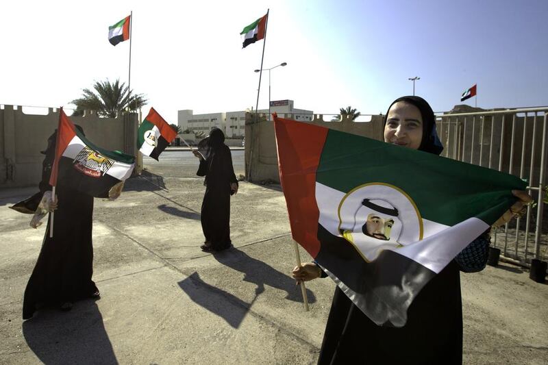 Three women who work at the women’s society school for adults in Umm al Quwain prepare for Flag Day. Jaime Puebla / The National