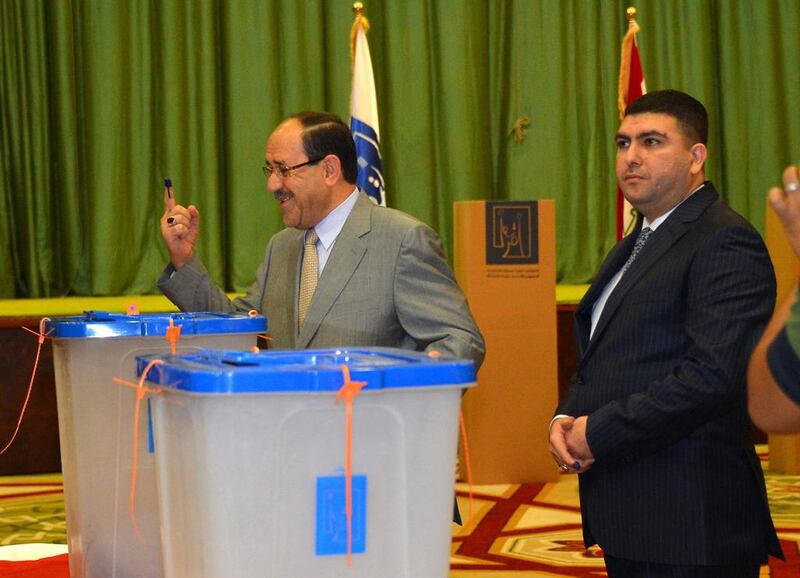 The Iraqi prime minister Nouri Al Maliki shows his ink-stained finger after casting his vote inside the heavily fortified Green Zone in Baghdad on April 30, 2014. AP Photo 