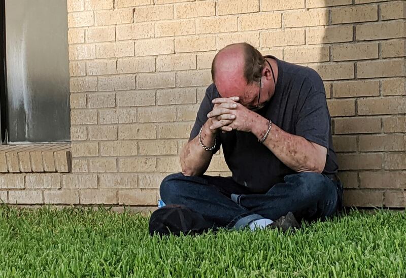 A man prays outside of the Medical Center Hospital Emergency room in Odessa following a shooting at random in the area of Odessa and Midland. Several people were dead after a gunman who hijacked a postal service vehicle in West Texas shot more than 20 people, authorities said Saturday. The gunman was killed and a few law enforcement officers were among the injured. AP