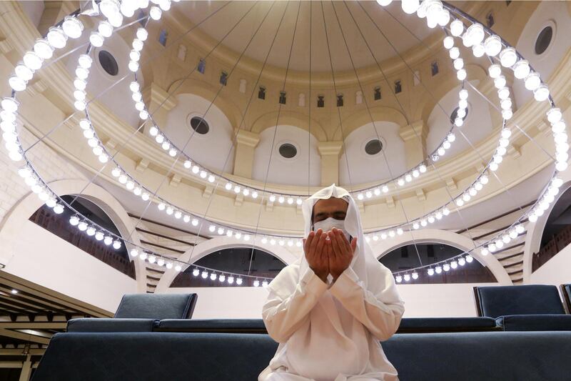 A Saudi man wearing a protective face mask performs the Al Fajr prayer inside the Al Rajhi Mosque. Reuters