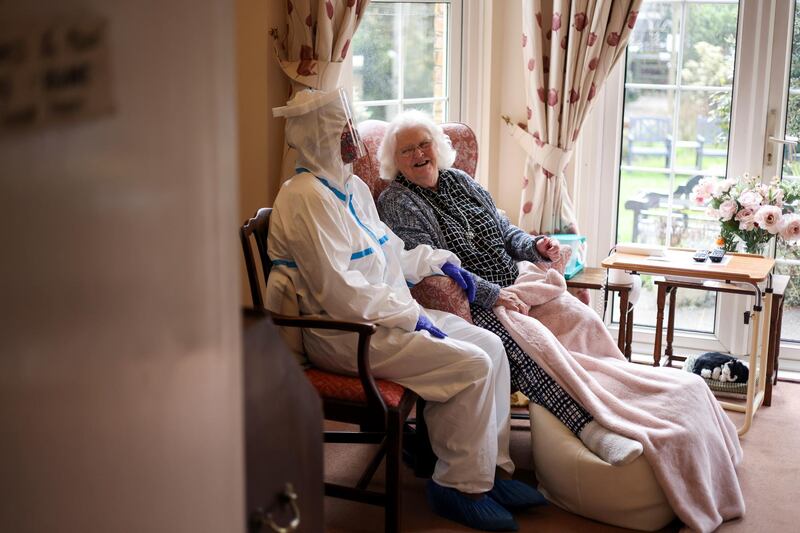 Nicky Clough visits her mother Pam Harrison in her bedroom at Alexander House Care Home for the first time since the lockdown restrictions began to ease, in London. Reuters