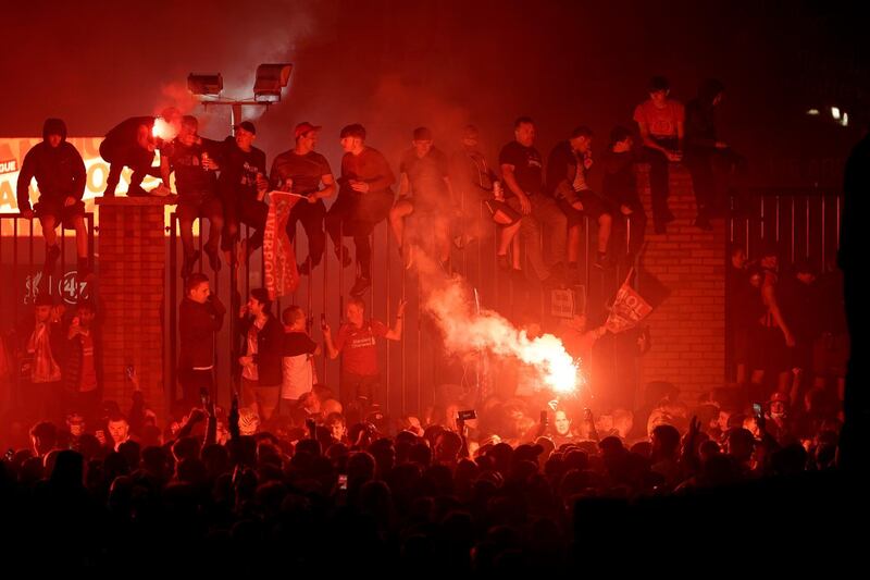 Liverpool fans celebrate outside Anfield stadium. Getty