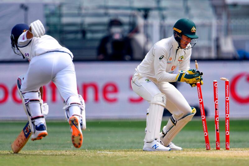 Australia's wicketkeeper Tim Paine runs out  Ajinkya Rahane. AFP