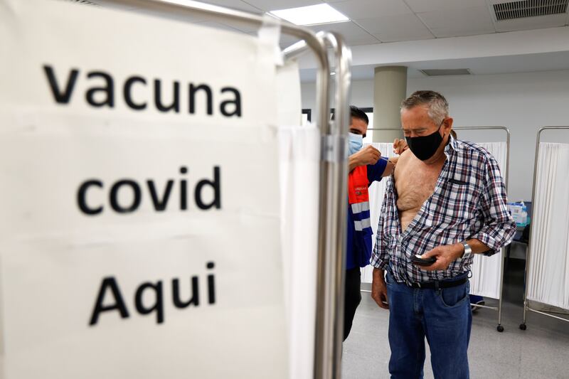 An elderly man receives a coronavirus vaccine booster coinciding with the flu vaccination campaign in Seville. Reuters
