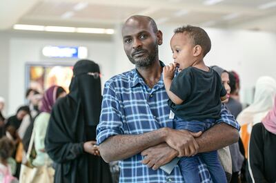 Emad Hassan and his family landed at Abu Dhabi International Airport on Sunday.  Khushnum Bhandari / The National