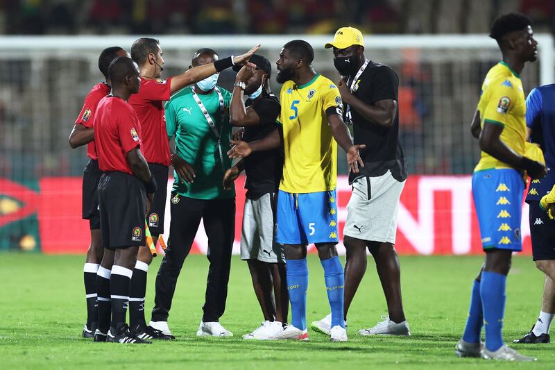 Gabon's defender Bruno Ecuele Manga, second right, appeals to referee Lahlou Benbraham after a scuffle at the Stade Ahmadou Ahidjo in Yaounde. AFP