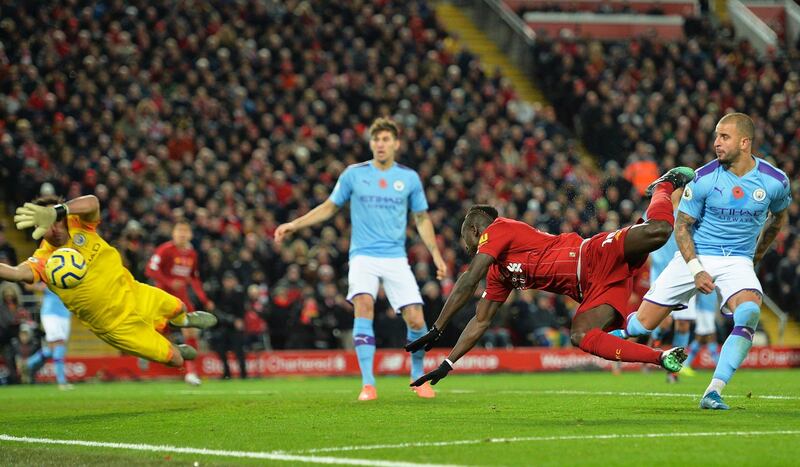 Sadio Mane, second right, scores the third goal for Liverpool against Manchester City. EPA