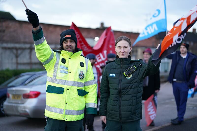 Workers wave flags on a picket line outside the East Midlands Ambulance Service in Nottingham, as members of the Unison and GMB trade unions take industrial action. PA