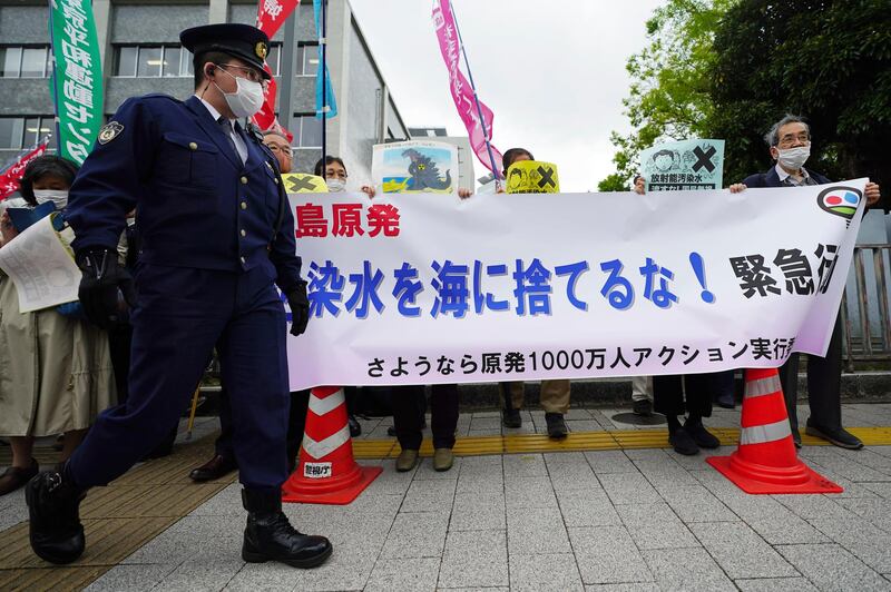 People hold a banner that reads "Don't dump radioactive water into the sea" during a rally outside the prime minister's office in Tokyo. AP