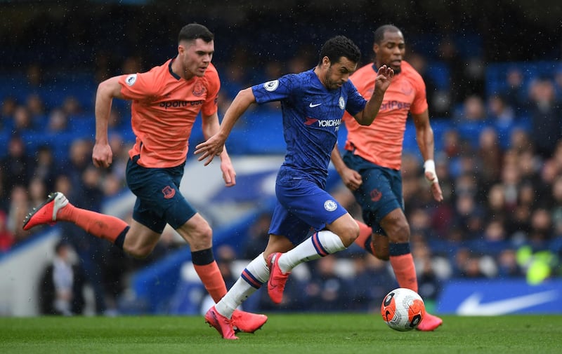 Pedro of Chelsea breaks away from Michael Keane and Djibril Sidibe of Everton during their Premier League match on March 8. Getty Images