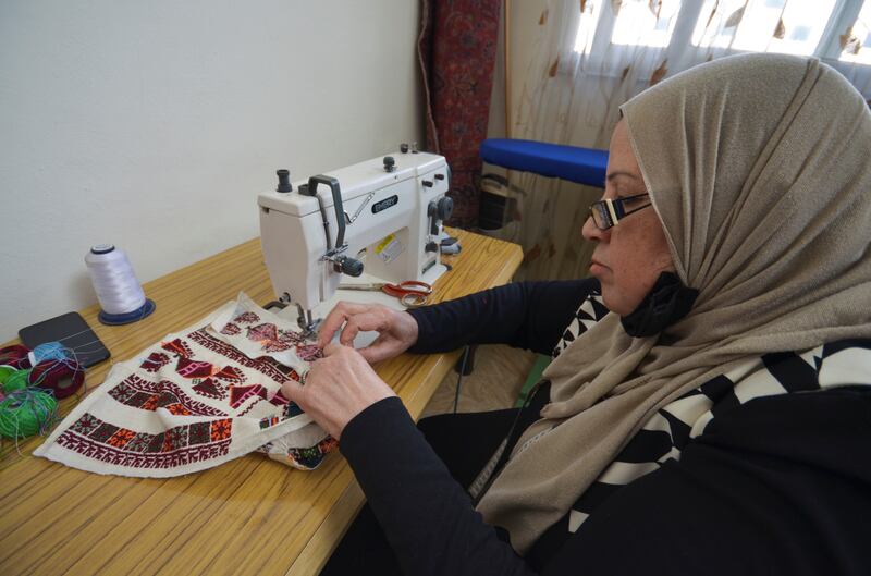 Prohect member Bushra Al Abaidi puts together pieces of traditional Palestinian costume.