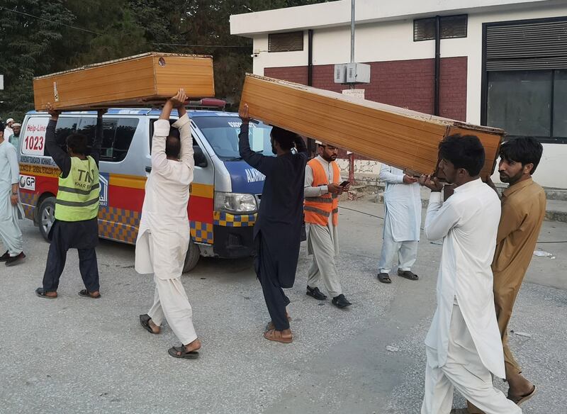 People take coffins to collect bodies of the victims outside a hospital after the blast.   EPA 