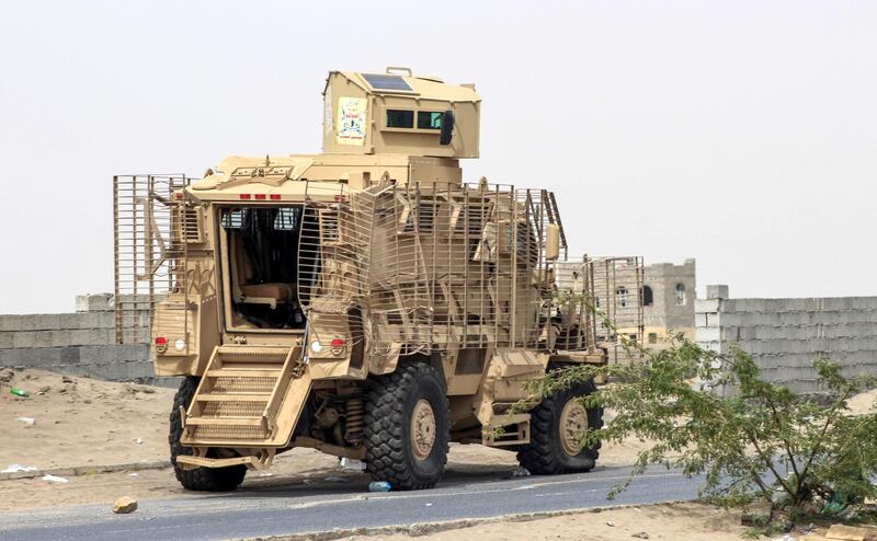 An armoured vehicle belonging to the Amalqa ("Giants") Brigades, loyal to the Saudi-backed government, parked on the side of a road during the offensive to seize the Red Sea port city of Hodeidah from Iran-backed Houthi rebels, on its southern outskirts near the airport on June 21, 2018. Saleh Al-Obeidi / AFP