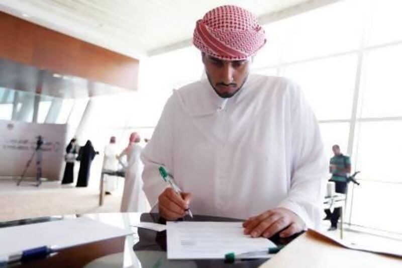 Khalfan Al Neaimi, a third-year business and economy student, applies for one of the 60 positions on offer at the Emirates Transport job fair at the InterContinental Hotel in Dubai yesterday. Sarah Dea / The National