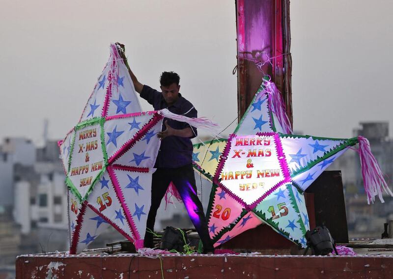 A man installs decorations on top of a church on Christmas eve in the western Indian city of Ahmedabad, India.  Amit Dave / Reuters