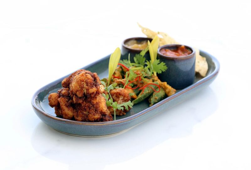 Dubai, United Arab Emirates - May 16, 2019: Iftar Signature Dish. Cauliflower Pakoras,ÊCrispy okra Balti, lime & mint pickle, and mango & apple chutney from Hillhouse Brasserie. Thursday the 16th of May 2019. Dubai Hills Golf Club, Dubai. Chris Whiteoak / The National

Chefs description: A sharing dish that introduces a nice combination of flavours, our Cauliflower Pakoras are fresh, versatile and healthy, making it the perfect dish to start your Iftar with. Loved by all, the Cauliflower Pakoras is ideal for everyone regardless if theyÕre vegan, vegetarian, gluten-free or even if theyÕre not on any diet.