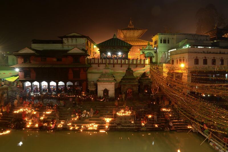Nepalese devotees light oil lamps at the Pashupatinath Temple in Kathmandu. AFP
