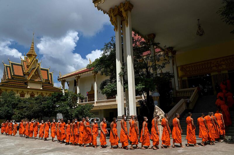 Buddhist monks walk in line to get lunch during the Pchum Ben festival (Festival of Death) at a pagoda in Phnom Penh. AFP