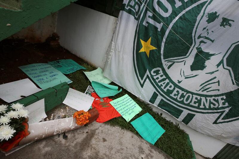 Flowers and messages are seen next a Chapecoense football team flag in tribute to their players in front of the Arena Conda stadium in Chapeco, Brazil. Paulo Whitaker / Reuters