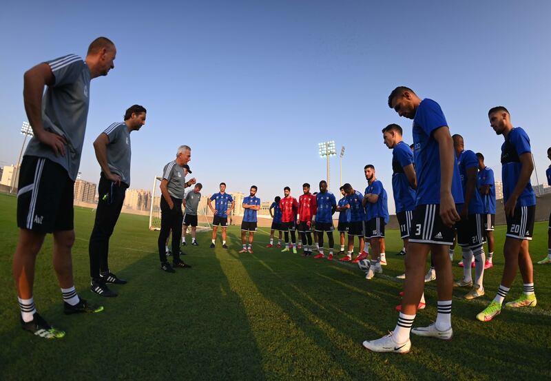 UAE manager Bert van Marwijk speaks to the players during the training session.