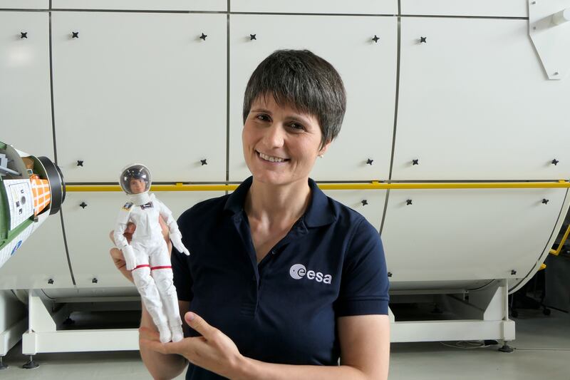 Italian astronaut Samantha Cristoforetti poses with the new Barbie doll modelled on her. Reuters