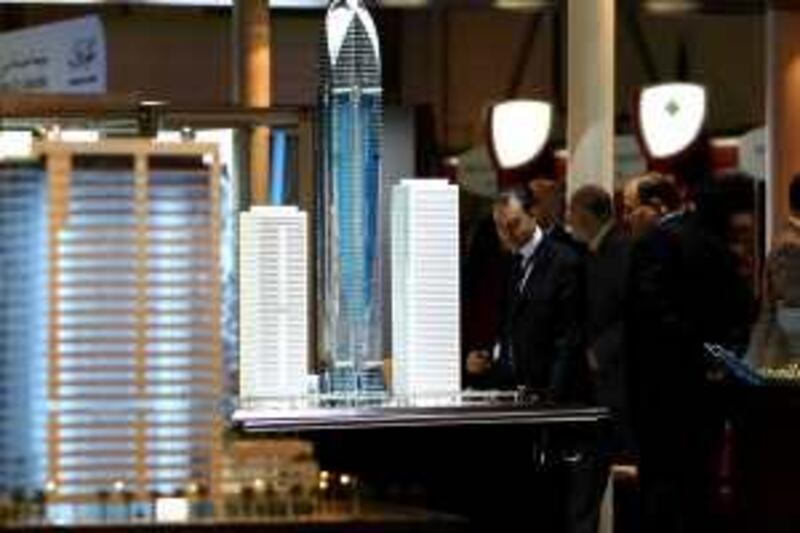 DUBAI-FEBRUARY 15,2009 - Visitors view the scale model buildings on display at the exhibition  during the International Property Show 2009 at Dubai International Exhibition Centre in Dubai. ( Paulo Vecina/The National )  *** Local Caption ***  PV Exhibition 1.JPG