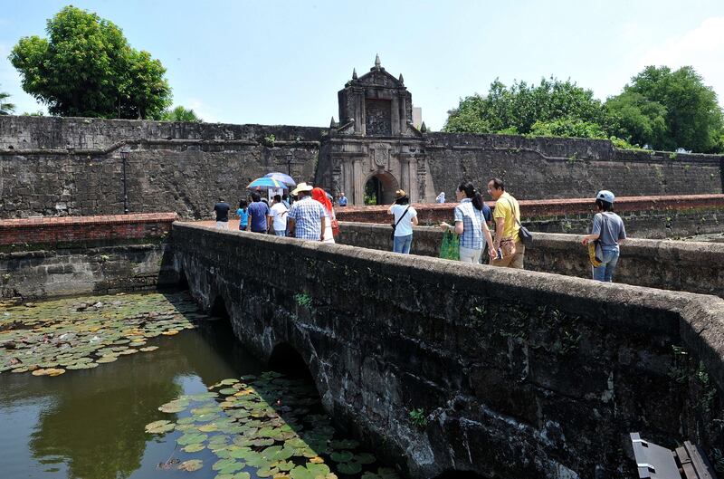TO GO WITH AFP STORY "Philippines-tourism,INTERVIEW" by Cecil Morella<br />People visit Fort Santiago, a defense fortress built built in 1571 for Spanish conquistador Miguel Lopez de Legazpi, in Manila on July 11, 2010. The Philippines is aiming to double tourism revenues in six years while avoiding the mass-market route taken by some of its Southeast Asian neighbours, the country's new tourism minister told AFP. The archipelago of more than 7,000 islands boasts some of the world's most beautiful white-sand beaches but annual tourist revenues are a paltry 2.25 billion USD, Tourism Secretary Alberto Lim said in an interview.  AFP PHOTO / JAY DIRECTO *** Local Caption ***  986926-01-08.jpg