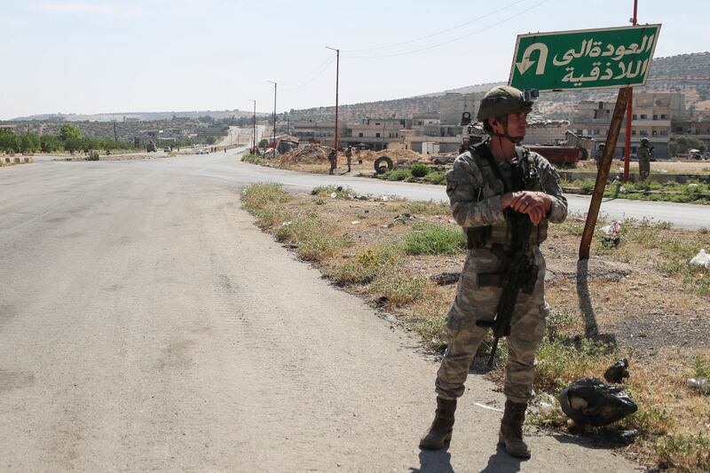 Turkish soldiers secure a section of the M4 to allow  joint Russian-Turkish patrol to pass.