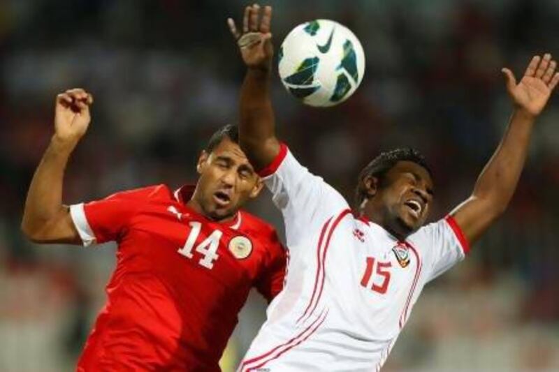 Bahrain's Abdulwahab Ali, left, fights for the ball with UAE's Ismail Salem. Fadi Al-Assaad / Reuters