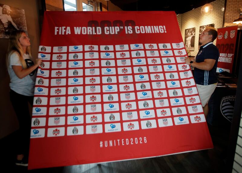 Sporting Kansas City soccer staff prepare for a reception celebrating a successful regional World Cup bid involving Canada, Mexico and the United States, in Kansas City, Mo., Wednesday, June 13, 2018. (AP Photo/Orlin Wagner)