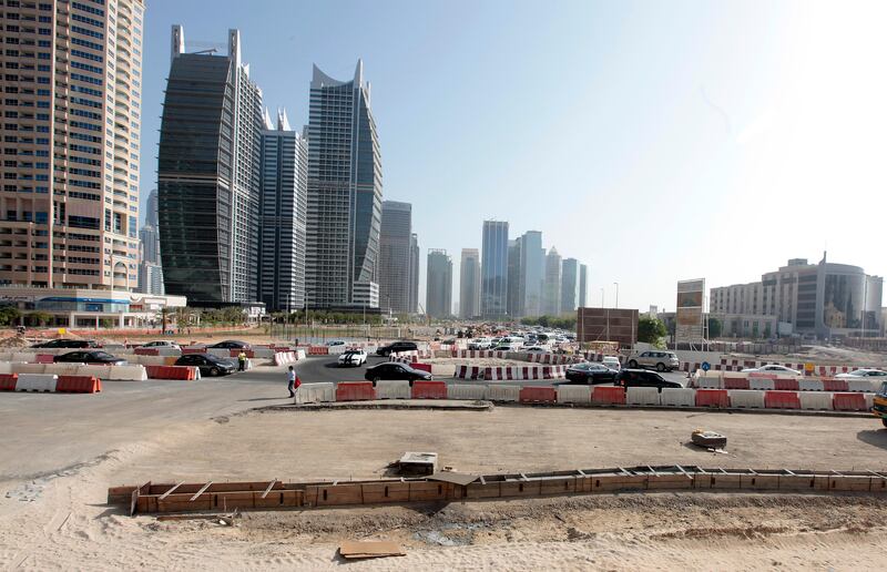 Dubai, United Arab Emirates - September 10, 2013.  Traffic building up as early as 8:30 am in this small temporary roundabout at the back of the JLT towers but slowly improving due to securities or traffic enforcers around the area, road construction in JLT is still ongoing.   ( Jeffrey E Biteng / The National )  Editor's Note;  Caline M reports. *** Local Caption ***  JB100913-Traffic03.jpg