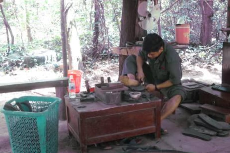 A shoemaker carves Vietcong-era sandals out of black rubber tyres at the Cu Chi tunnel site in northern Ho Chi Minh City. During the Vietnam War, the sandals were used by police and military forces to identify Vietcong operatives. Photo by Effie-Michelle Metalidis