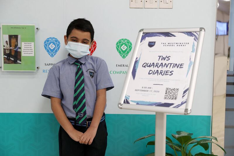 DUBAI, UNITED ARAB EMIRATES , September 21 – 2020 :- Mekaeel Mehdi student of grade 3 with the Digital Quarantine Diaries ( on the right) of 400 pages which is written by the students of The Westminster School in Al Qusais in Dubai.  (Pawan Singh / The National) For News. Story by Sarwat