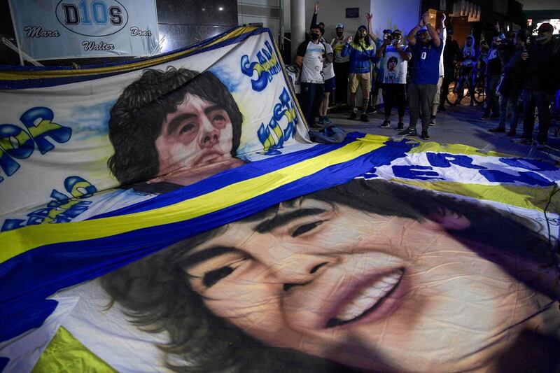Supporters of Diego Maradona gather outside the hospital where he undergoes a brain surgery for a blood clot, in Olivos, Buenos Aires . AFP