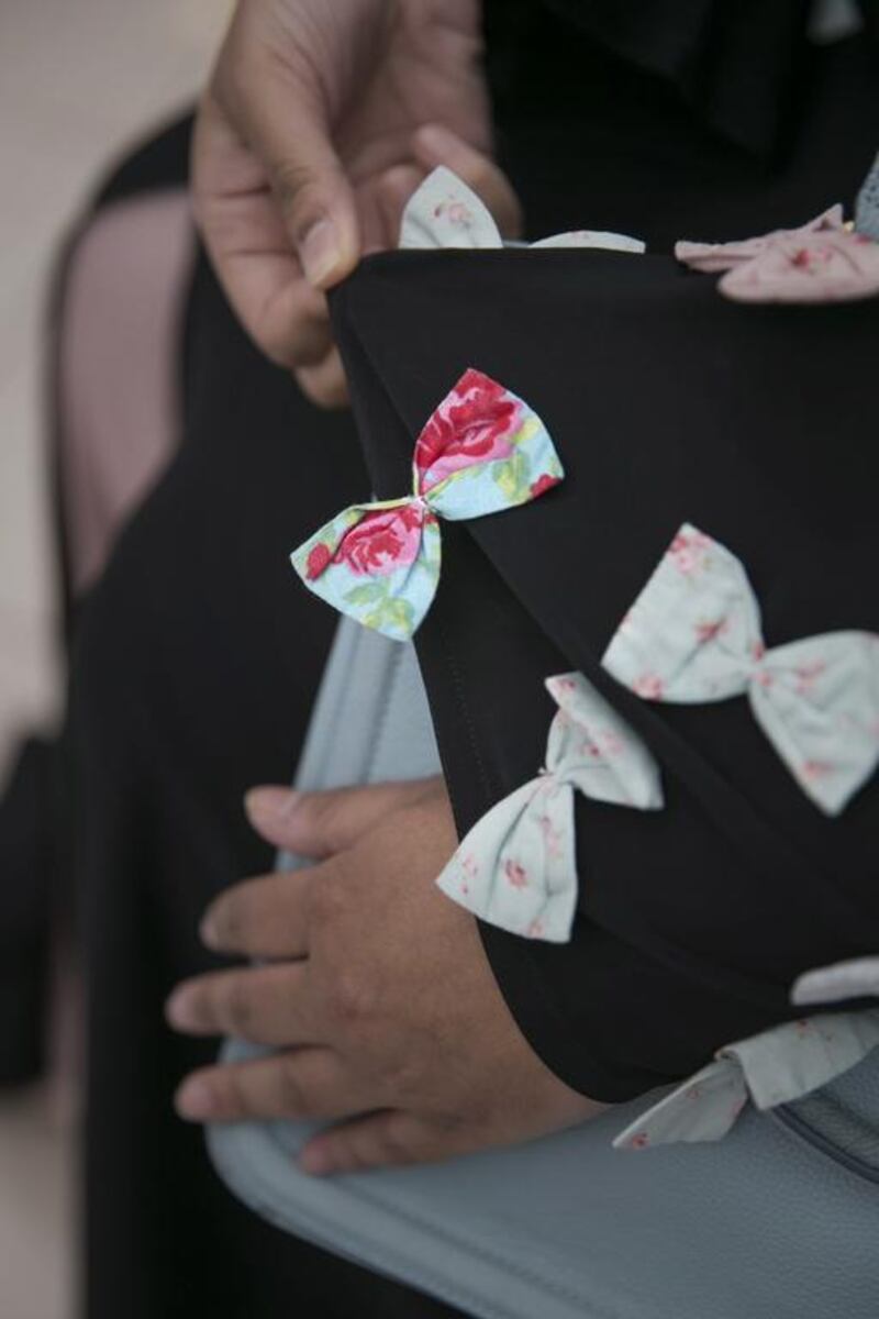 The wearer of this abaya, who did not want to give her name, says her sister designs abayas for her female relatives. “She likes ribbons, she’s my sister. Design depends on the person, first of all,” says the Emirati, 19, from Abu Dhabi. “The cut of the abaya changes every three or four months. The winter abaya differs from the summer or spring in fabrics and colour.”