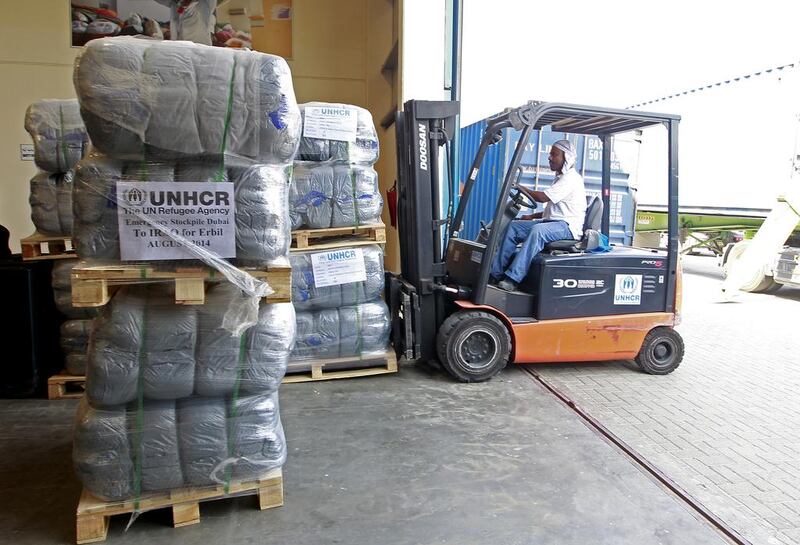 Blankets are loaded for shipping from the UNHCR stockpiles at International Humanitarian City in Dubai to Iraqi Kurdistan. Jeffrey E Biteng / The National