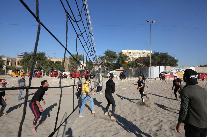 Iraqis play volleyball as they wind down on the bank of the Tigris river in the capital Baghdad. AFP