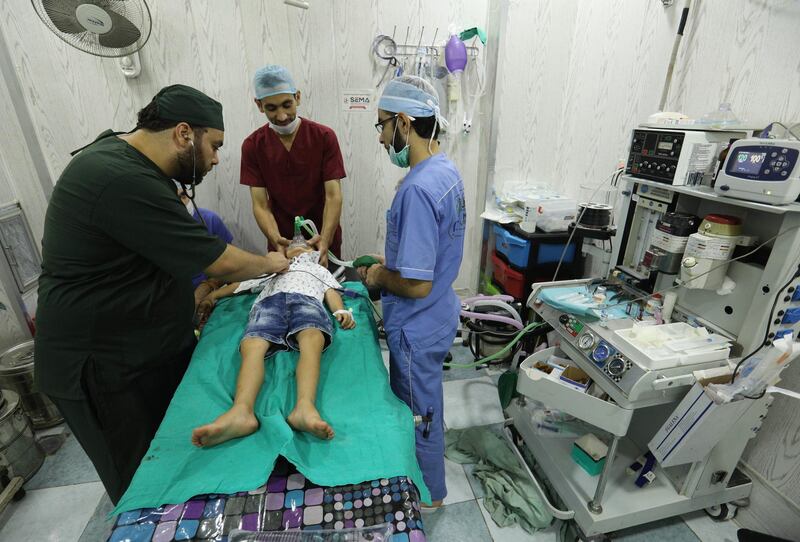 Syrian doctors offer treatment to a boy at a hospital in Idlib province, on September 4, 2018. - Aid agencies urged world powers to avoid "the greatest humanitarian catastrophe in Syria's seven-year war". Humanitarian workers "are already overwhelmed trying to provide shelter, food, water, schooling and healthcare," eight agencies said in a joint statement. (Photo by OMAR HAJ KADOUR / AFP)