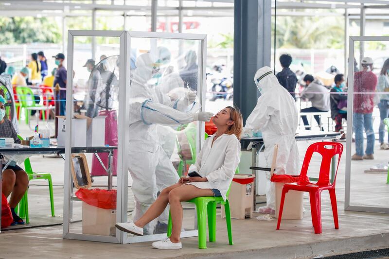 Thai health officials collect samples during a community Covid-19 nasal swab testing drive at a car park in Bangkok, Thailand.  EPA