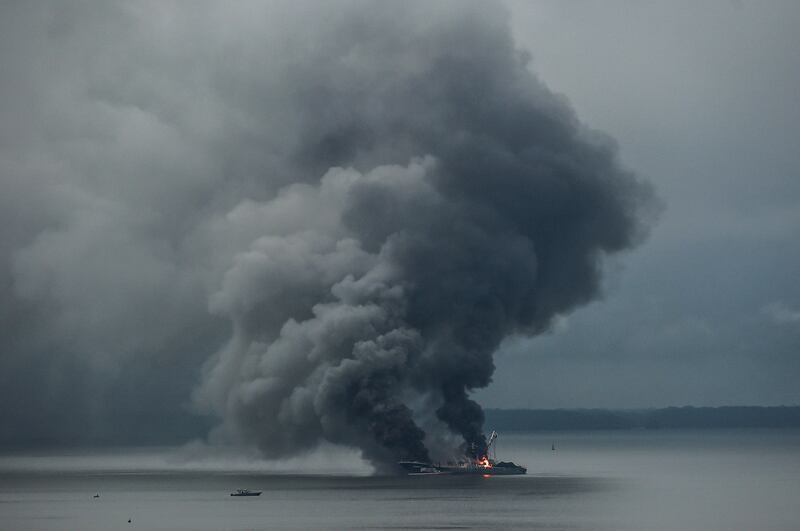 Smoke billows from the Venezuelan ship 'Taurus 1' in Buenaventura Bay, Colombia. Twenty-nine people were rescued after a fire broke out because of a short-circuit, the Colombian Navy said. AFP