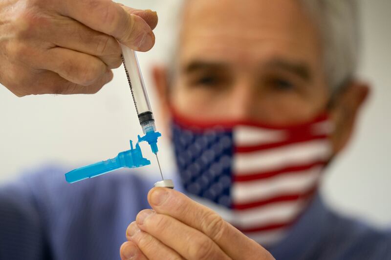 Dr Sydney Sewall fills a syringe with a Covid-19 vaccine at a clinic in Augusta, Maine, US. AP