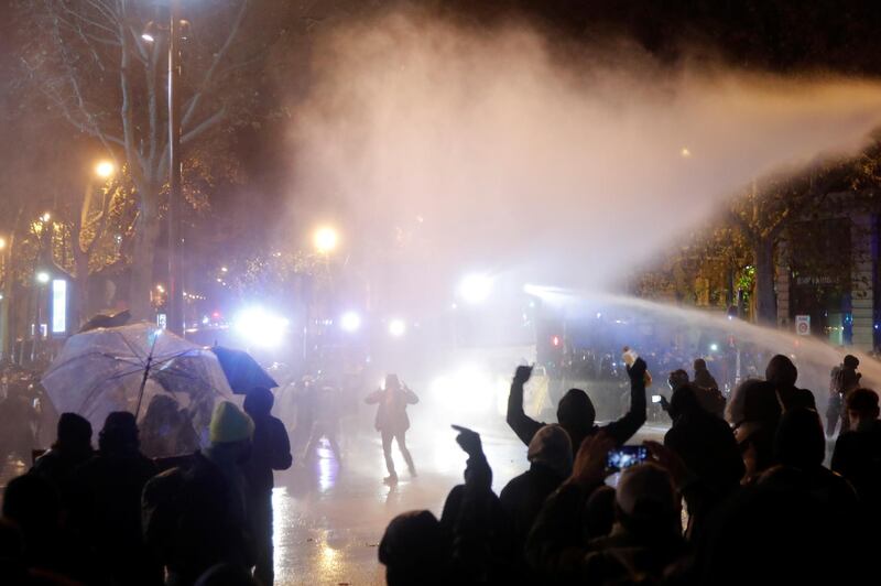 French police use a water cannon as they face off with demonstrators at the Place de la Republique during a demonstration against the "Global Security Bill'', that right groups say would make it a crime to circulate an image of a police officer's face and would infringe journalists' freedom in the country, in Paris, France, December 12, 2020.  REUTERS/Charles Platiau