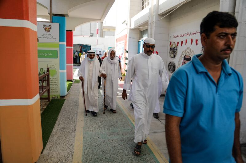 Men arrive to vote at a polling station on the Bahraini island of Muharraq.