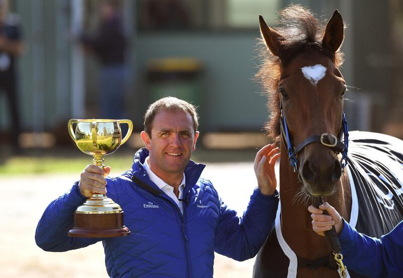 Trainer Charlie Appleby holds the Melbourne Cup in Melbourne on November 7, 2018, a day after the British horse Cross Counter won the 5.30 million USD race. / AFP / William WEST
