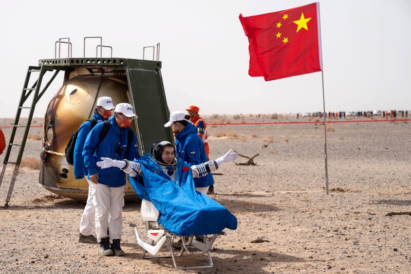 Chinese astronaut Ye Guangfu sits outside the capsule after six months aboard China's newest space station in the longest crewed mission to date for its ambitious space programme. AP