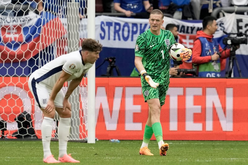 England's goalkeeper Jordan Pickford and John Stones react after Slovakia's Ivan Schranz scored the opening goal. AP 